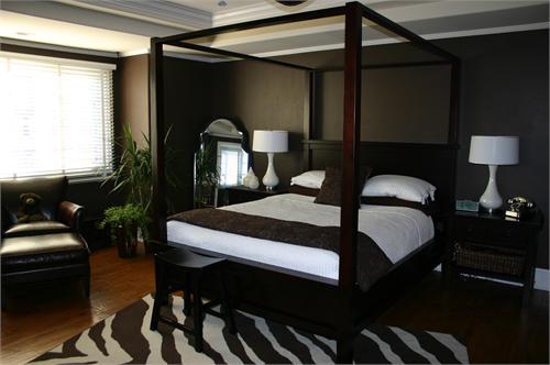 Dark chocolate walls, wood canopy bed, white bedding, wood nightstands ...